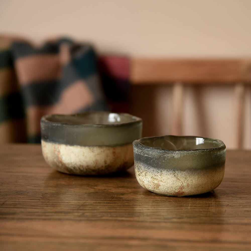 Two Charcoal glass tea light holders on a table