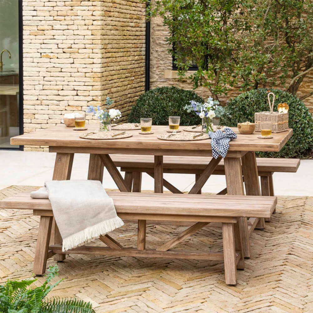 chilford dining set on a terrace with glasses and tableware