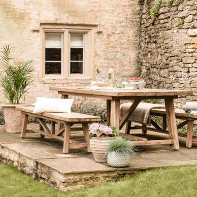 large chilford dining set on a terrace with glasses and tableware