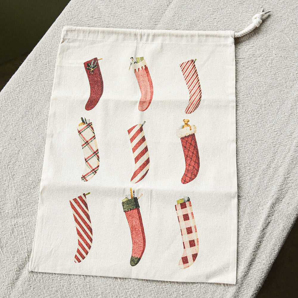 Decorative pouch with Christmas stocking designs on a gray surface