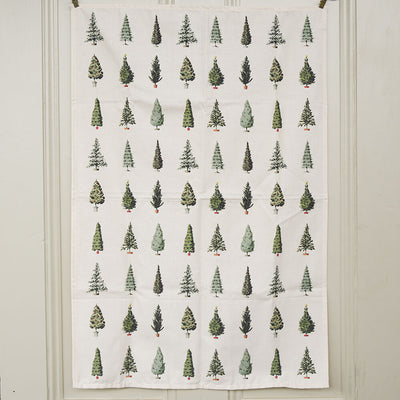 Fabric tea towel with green tree pattern hanging on a white door