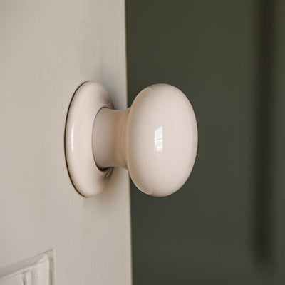 cream door knobs shot in profile on a door