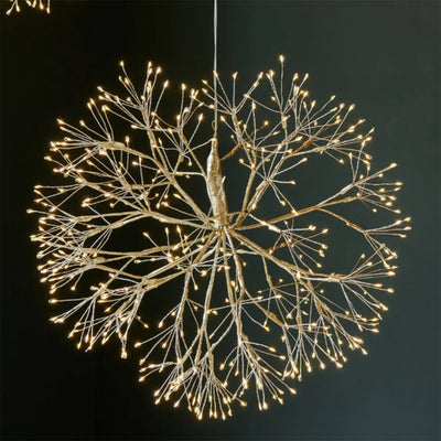 Decorative light fixture resembling a tree with illuminated branches on a dark background