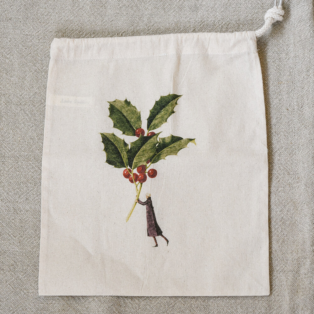 Drawstring bag with holly design on a textured surface
