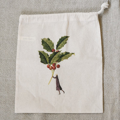 Drawstring bag with holly design on a textured surface