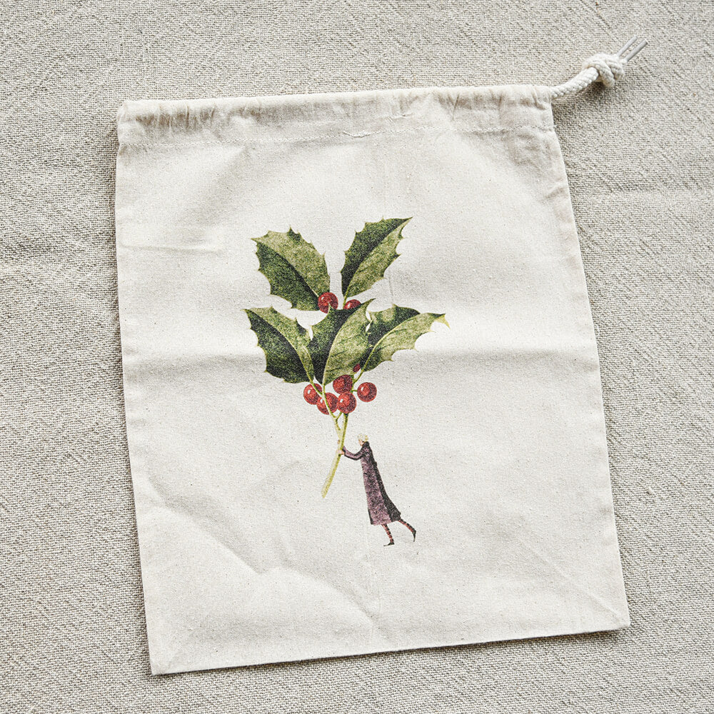 Drawstring bag with holly design on a textured surface