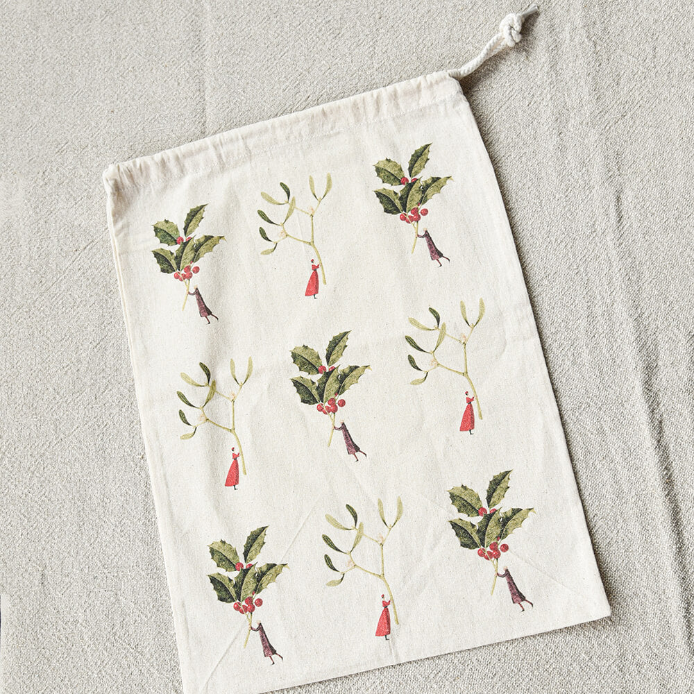 Drawstring bag with mistletoe design on a textured surface