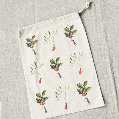 Drawstring bag with mistletoe design on a textured surface
