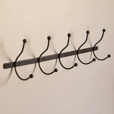 Iron row of five coat hooks