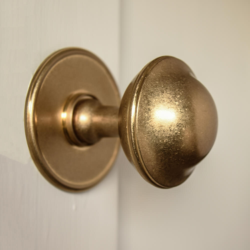 Large brass door pull on cream door