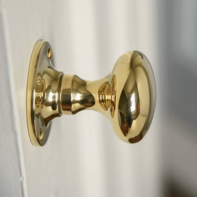 The profile of a Polished Brass Cushion Door Knobs with a smooth face and elegant curved design