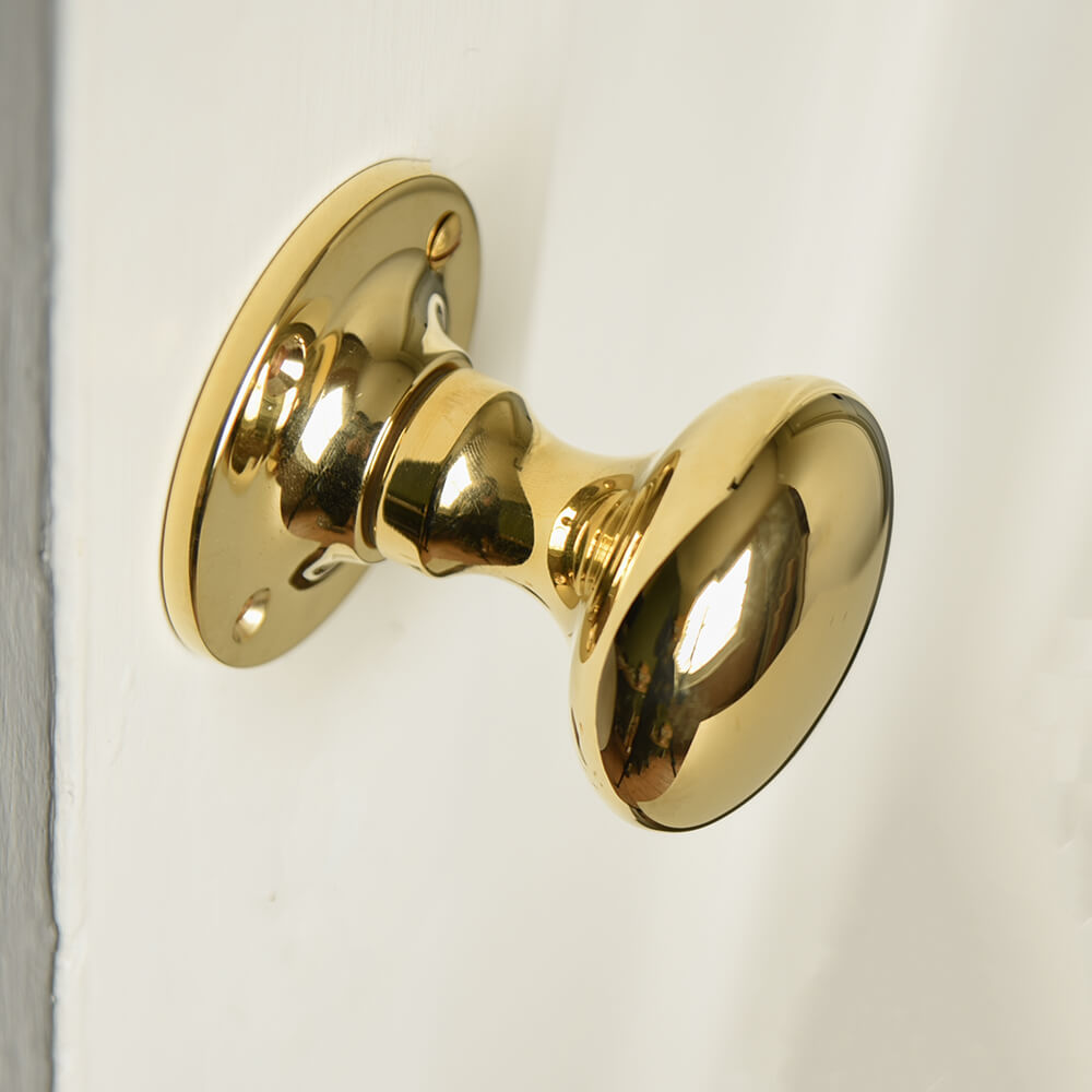 Polished Brass Cushion Door Knobs with a smooth face and elegant curved design