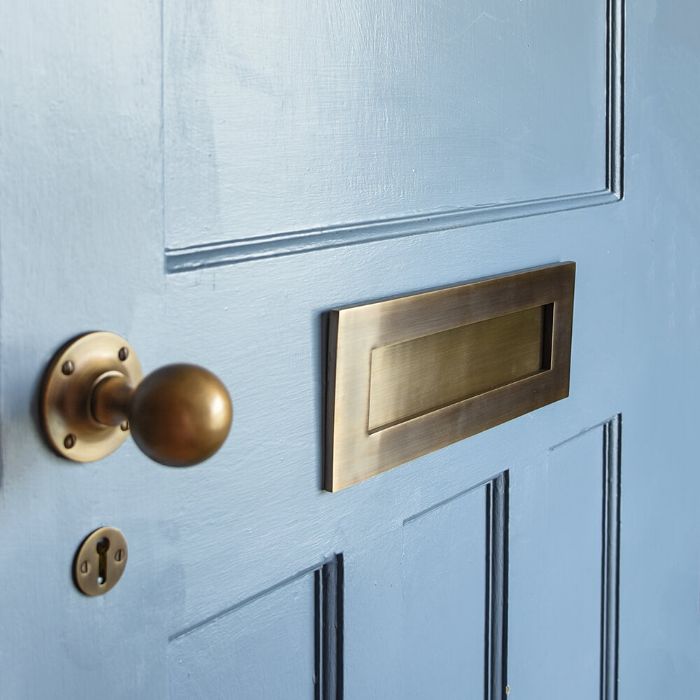 Light antique brass fittings on blue front door