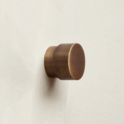 Bronze wall handle on a light beige background
