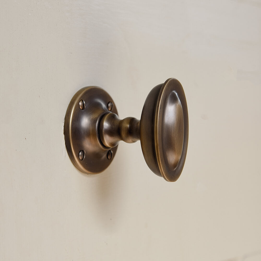Bronze door handle on a beige background