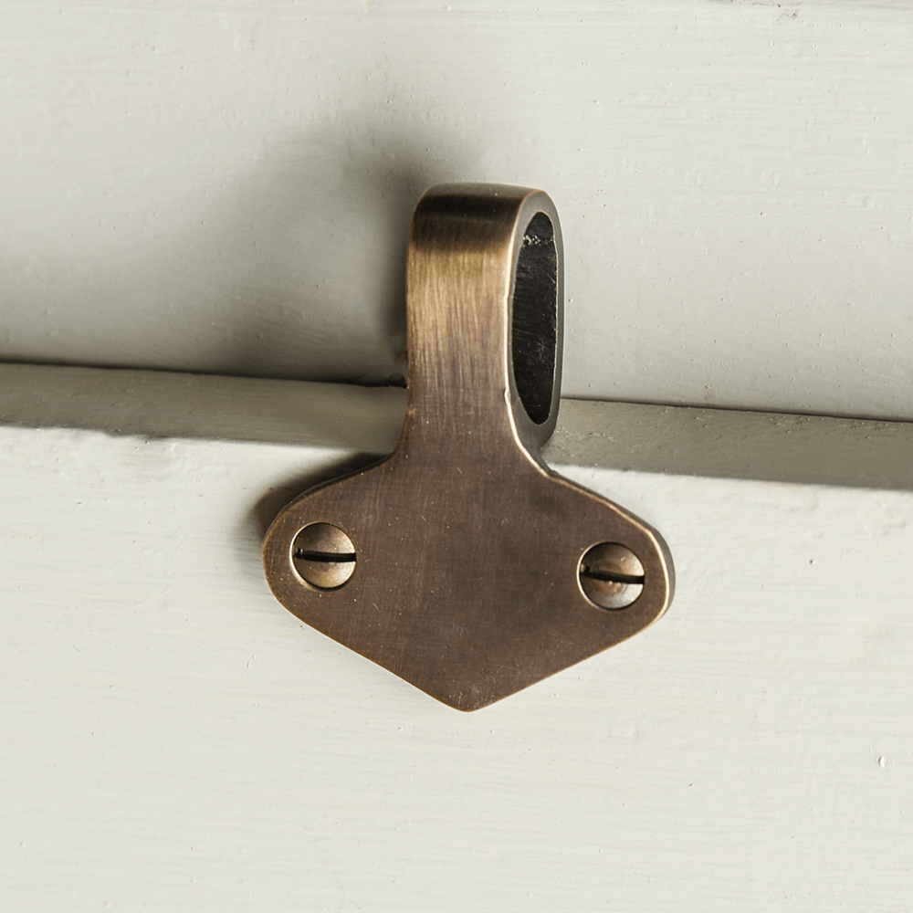 Brass sash window lift on a white background