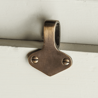 Brass sash window lift on a white background