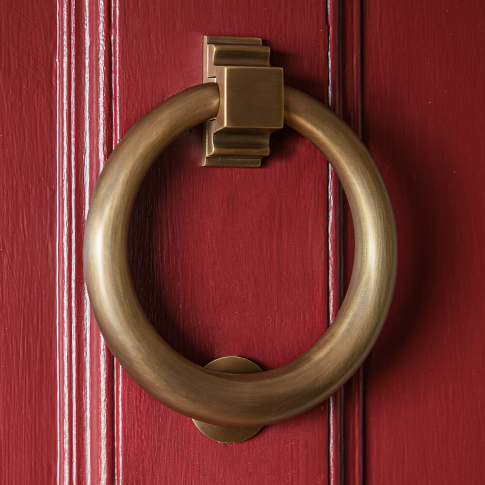 Light Antique Brass Large Hoop Door Knocker on a bright red front door