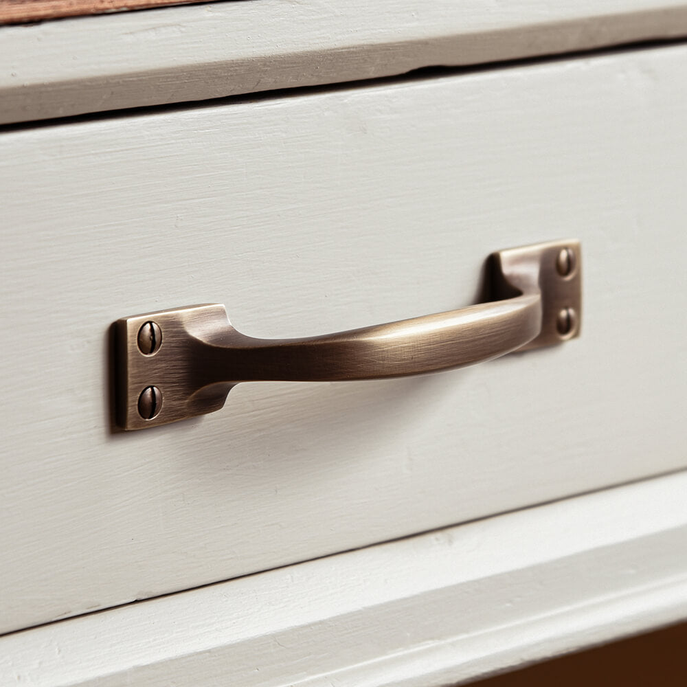 Antiqued brass handle on a drawer front