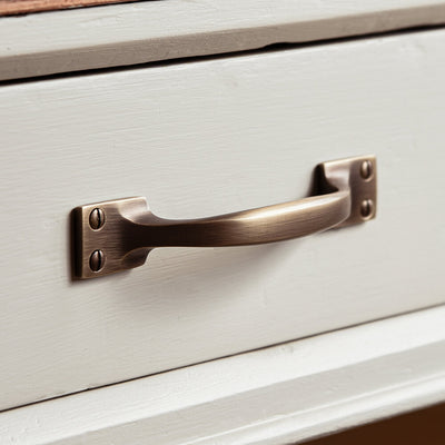 Antiqued brass handle on a drawer front
