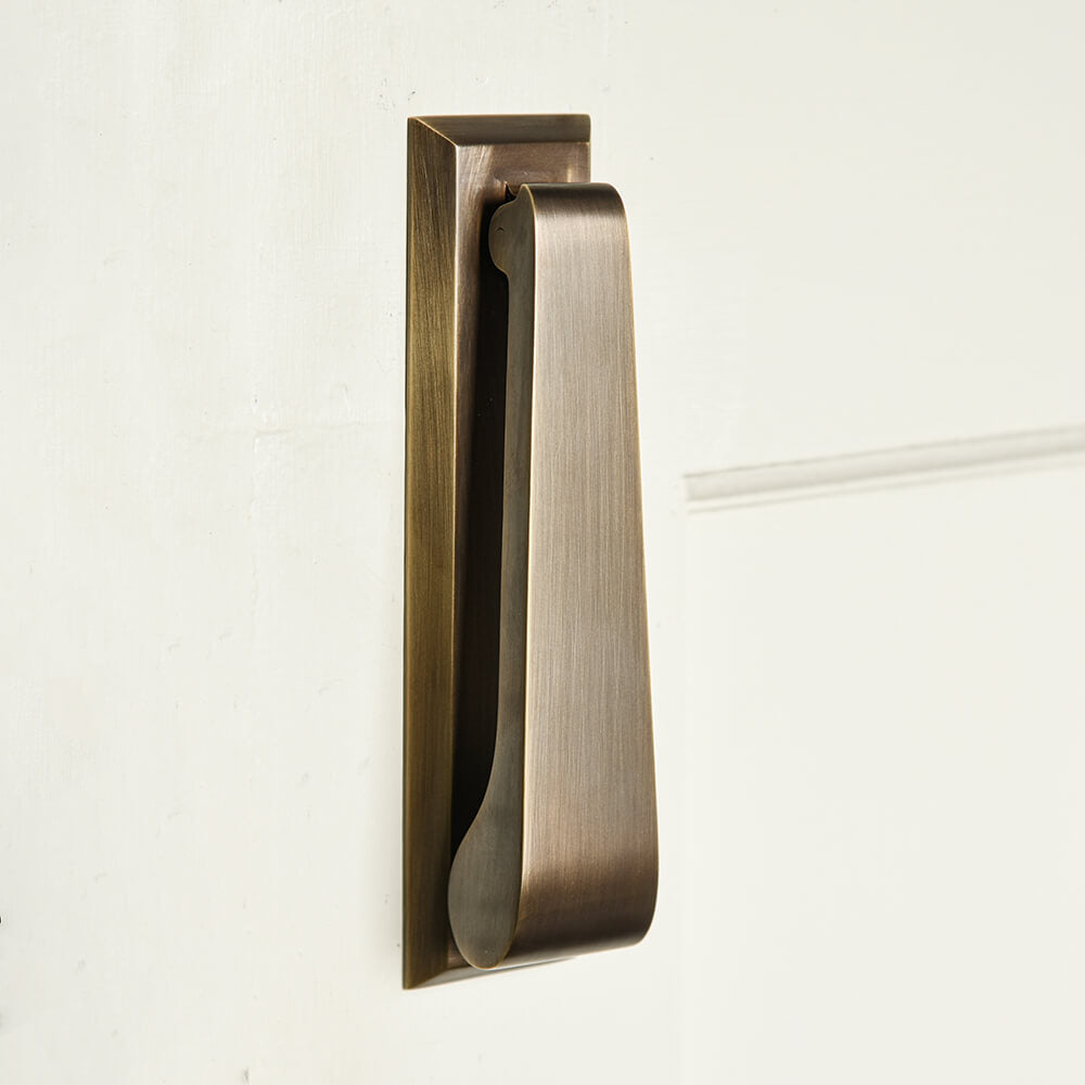 Slim door knocker in an elongated rectangular design