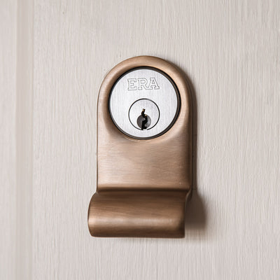 LIght antique brass latch pull for a cylinder shown in situ