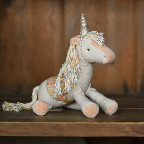 Unicorn pony toy in fabric on a shelf