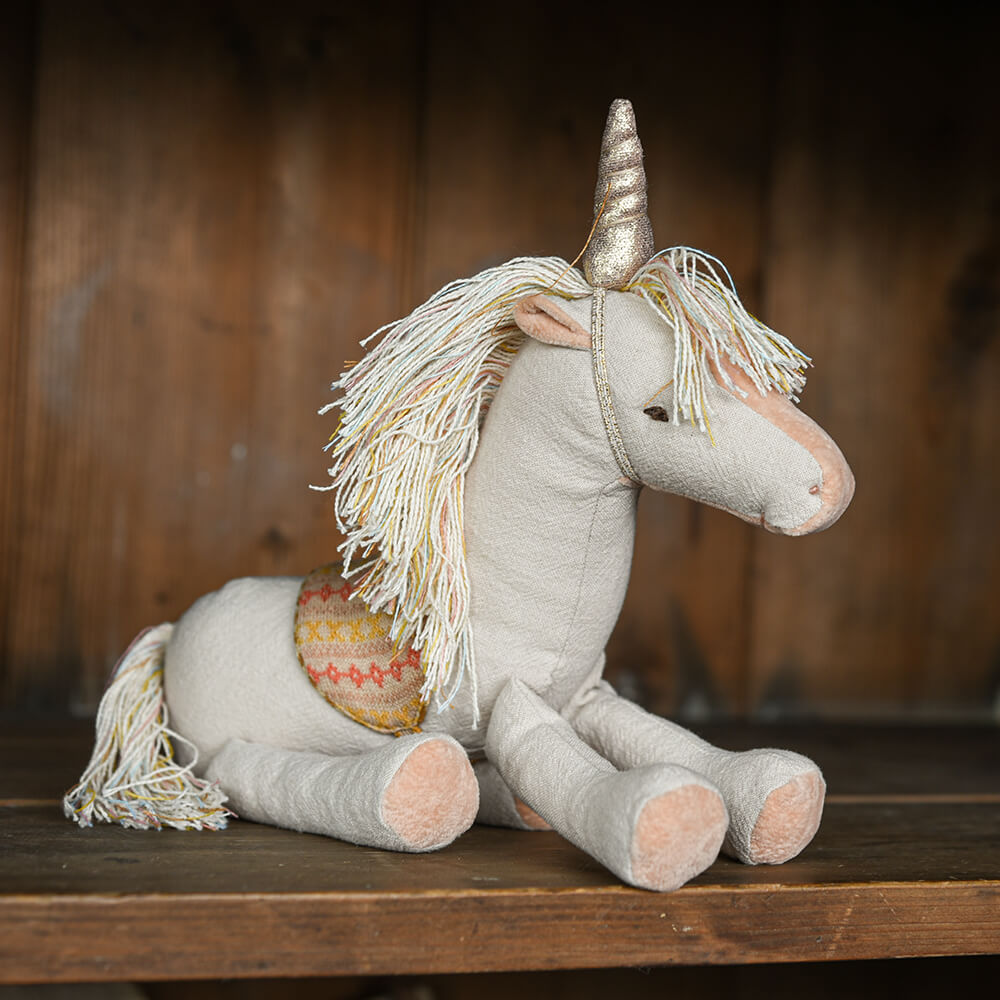 Unicorm soft toy on shelf