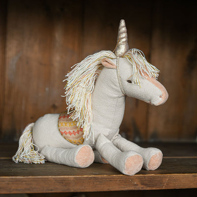 Unicorm soft toy on shelf