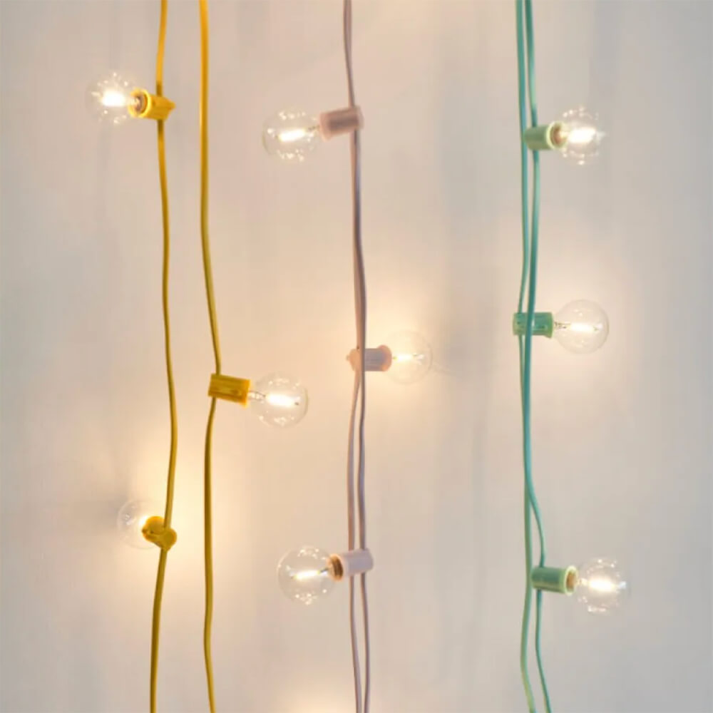 lengths of festoon lights, lit, in yellow, pink, and blue