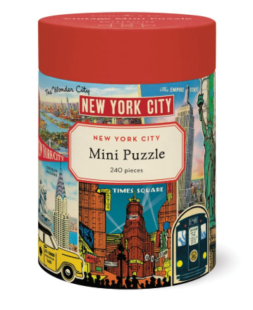 A cylindrical container with a red lid, featuring a New York City themed mini puzzle advertisement with iconic landmarks and a yellow taxi on the front.