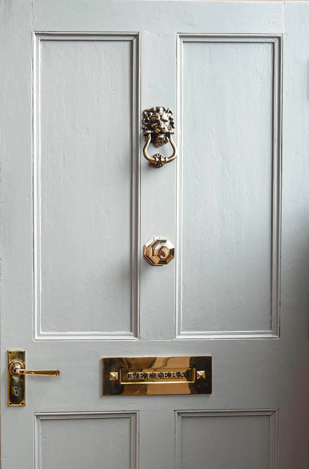Brass Door fittings on pale blue front door