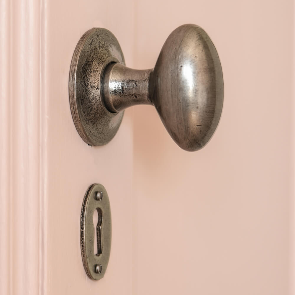 oval pewter door knob with matching escutcheon