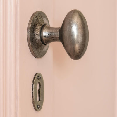 oval pewter door knob with matching escutcheon