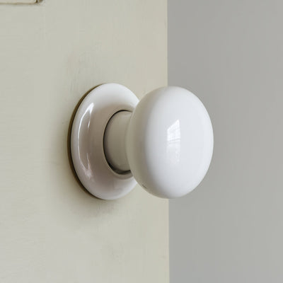 White ceramic door knob on door image 2