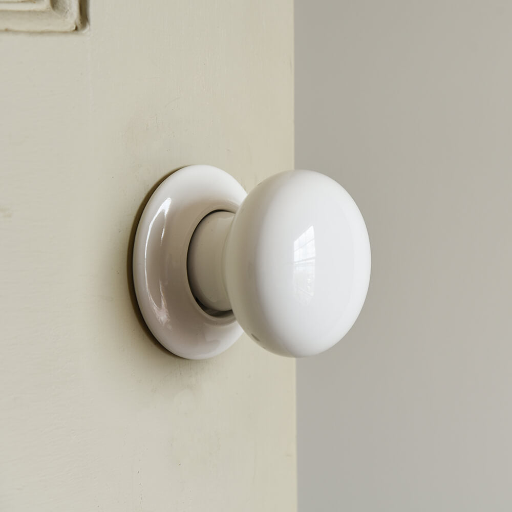 White ceramic door knob on door