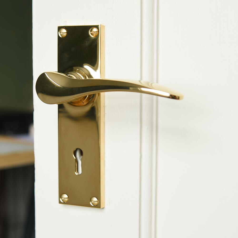 Polished-Brass-Penwerris-Lever-Handles-on-cram-door