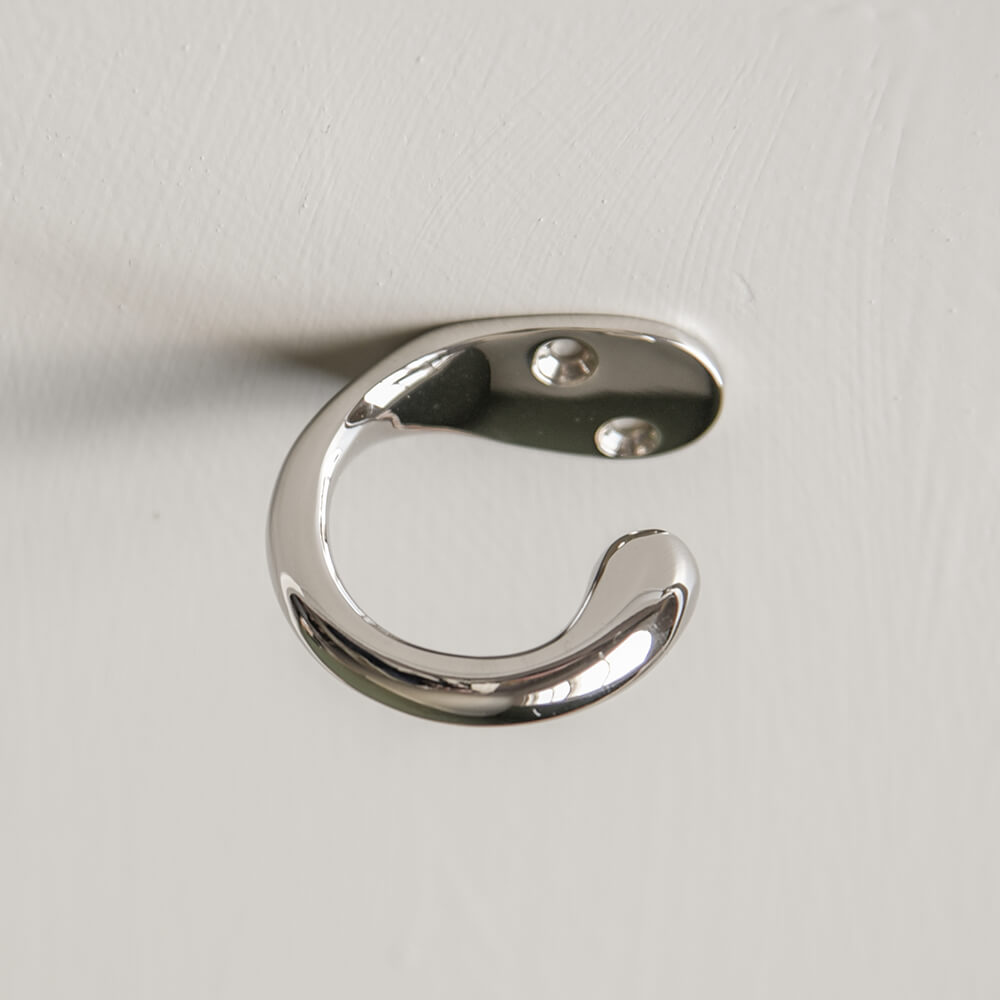 polishednickel curved hook fitted on the underside of a surface for the purpose of hiding a bag for example