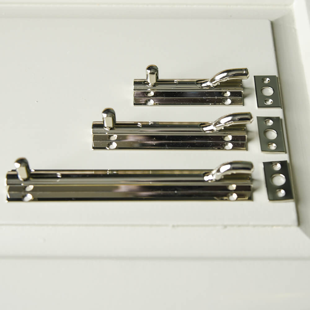 Row of polished nickel slide bolts showing the difference in size between the 3.