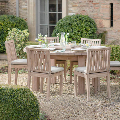Porthallow-round-dining-table-large in stylish garden setting