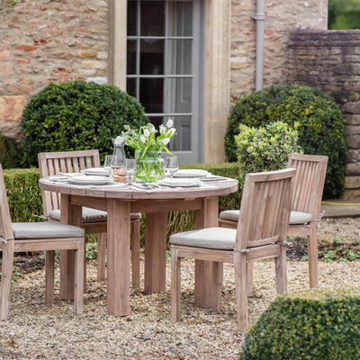 Porthallow-round-dining-table-medium.-in-garden