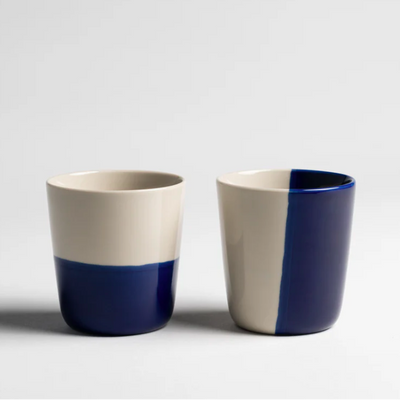 Two ceramic cups with blue and white color pattern on a light gray background