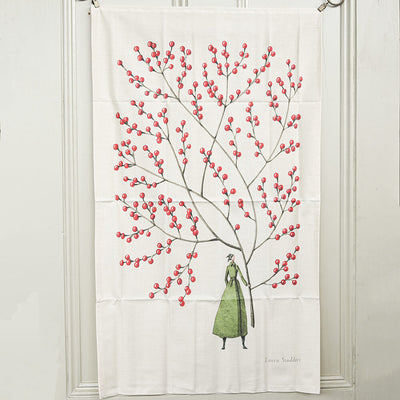 tea towel with a design of a woman under a tree with red berries on a white background