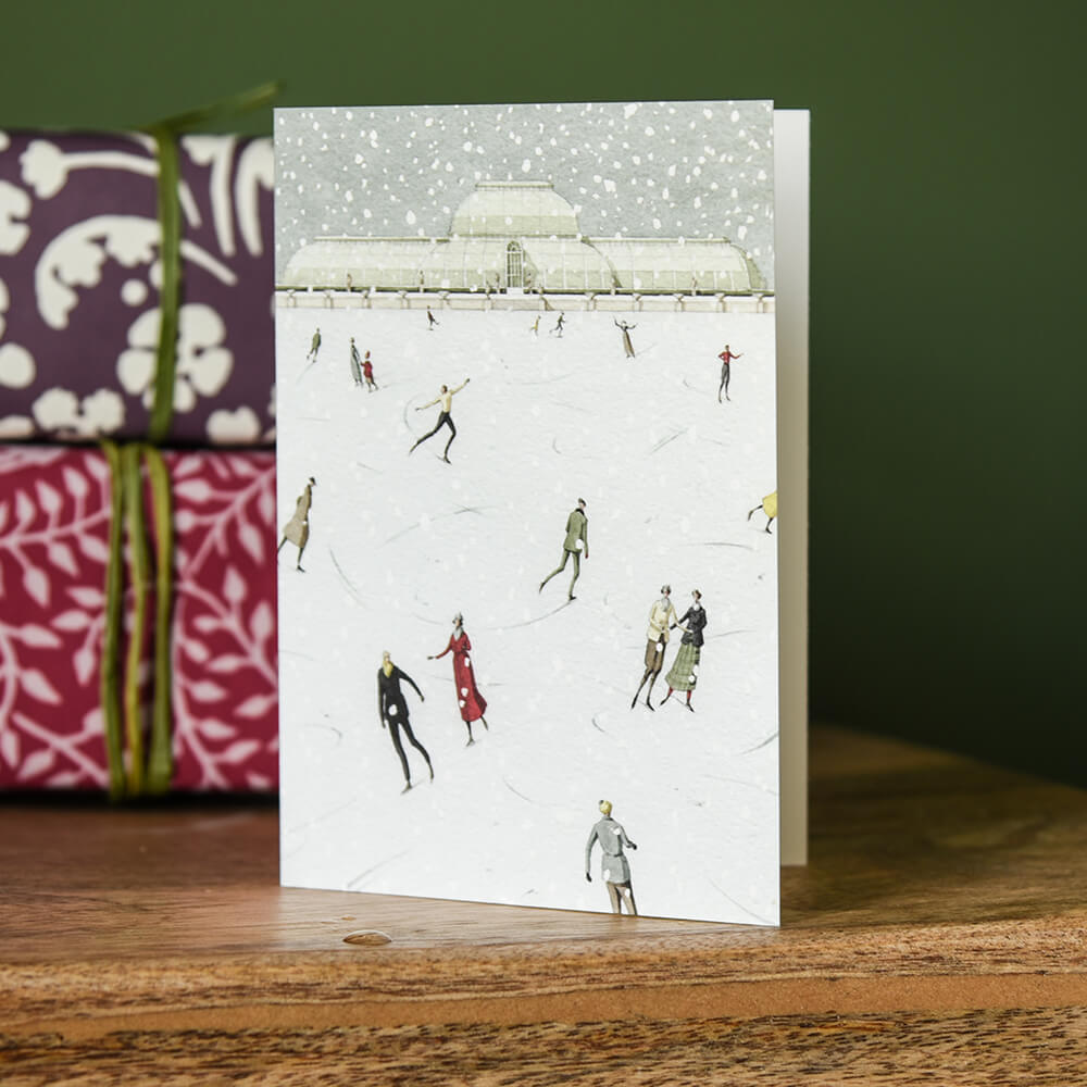 Card on a stool depicting ice skating at kew gardens
