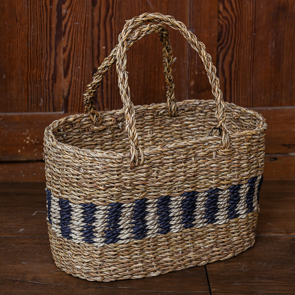 Woven basket with striped pattern on a wooden background