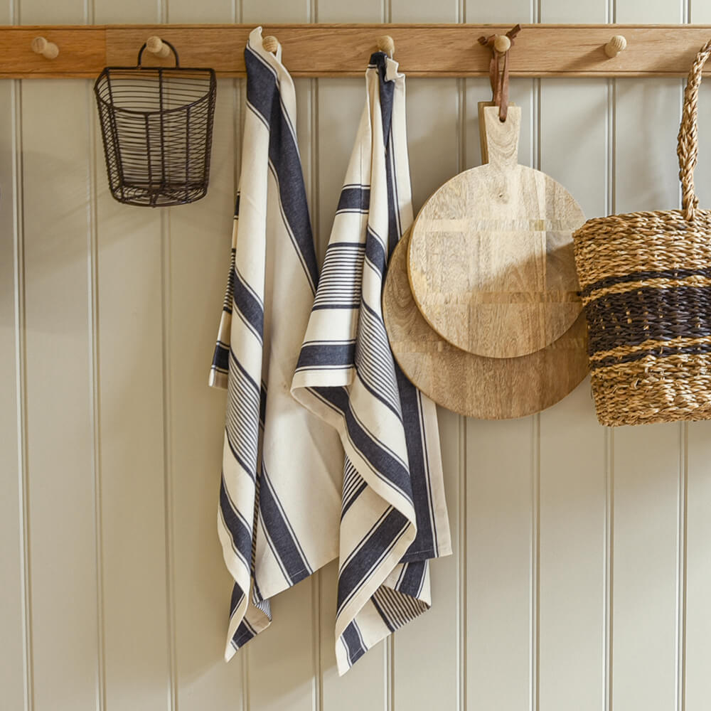 Towels hanging on a wooden rack with a neutral background