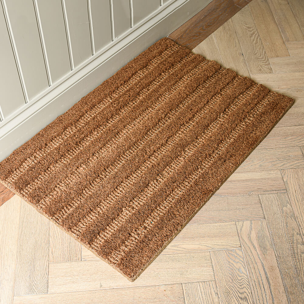 Brown doormat on a wooden floor