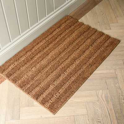 Brown doormat on a wooden floor