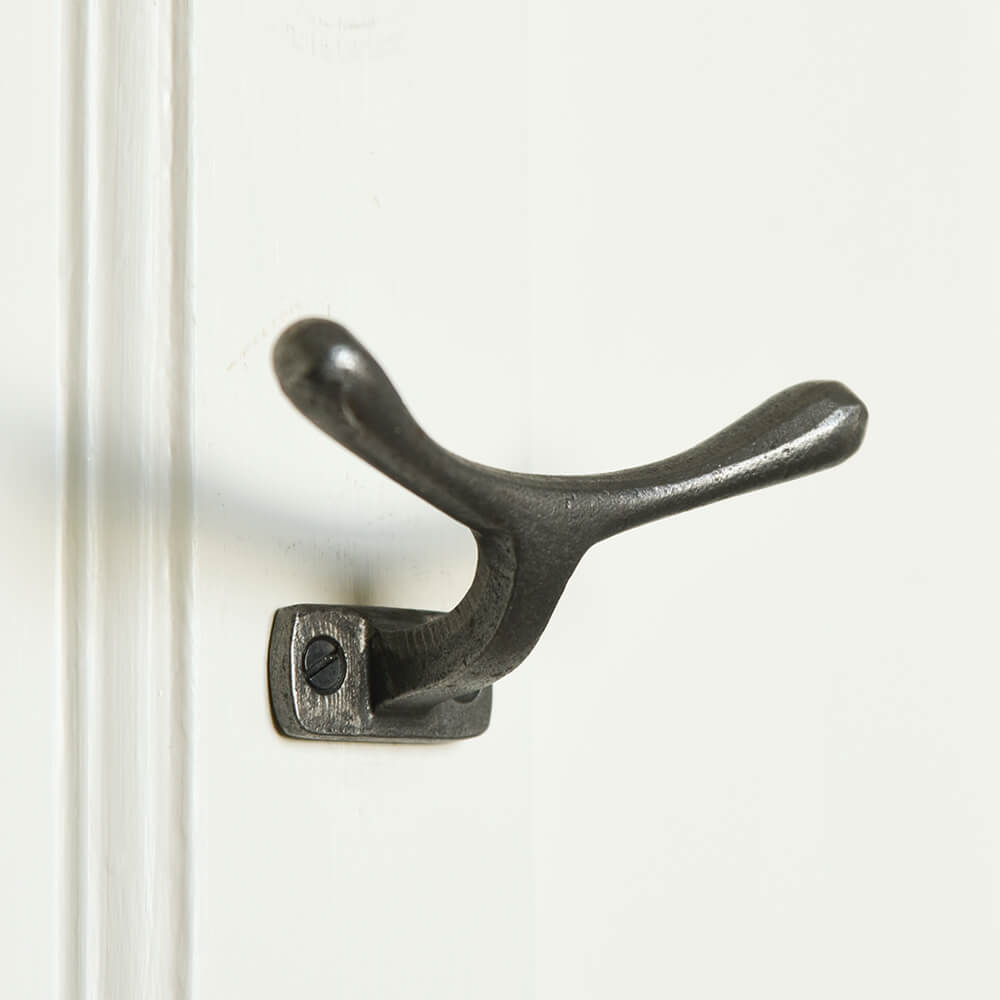 horizontal cast iron cleat hook mounted on a wall