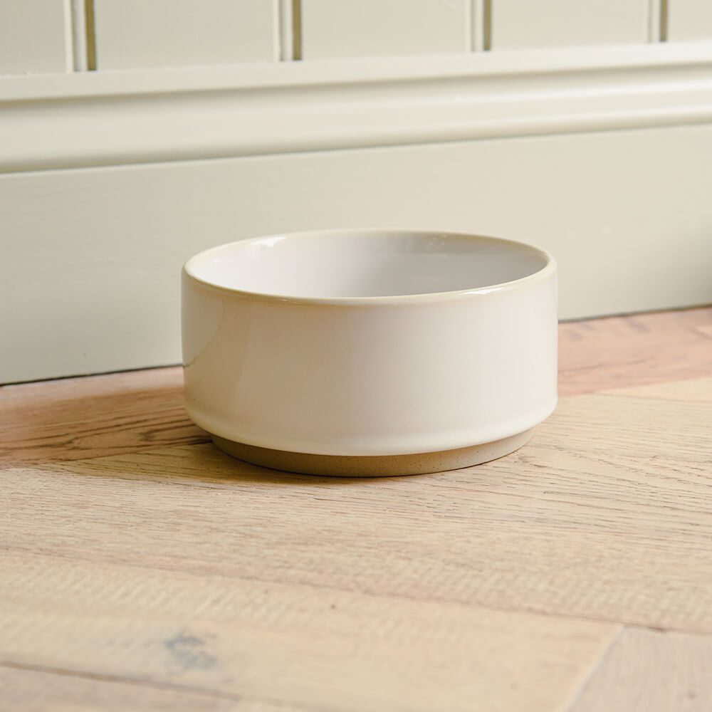White ceramic bowl on a wooden surface with a neutral background